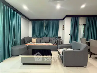Spacious living room with modern gray furniture and elegant teal curtains