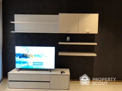 Modern living room with sleek TV unit and wall-mounted cabinets