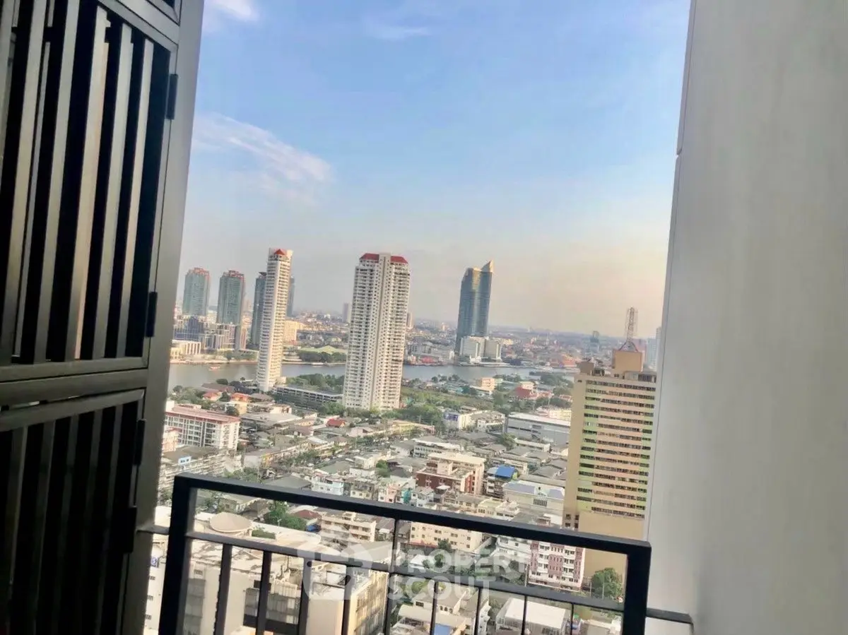 Stunning cityscape view from a high-rise balcony with skyline and river.