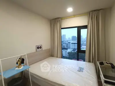 Cozy bedroom with city view, featuring a comfortable bed and large window for natural light.