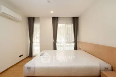 Spacious bedroom with large windows and modern minimalist design