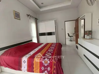 Spacious bedroom with modern furniture and vibrant bedding