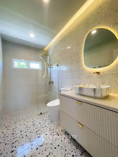 Luxurious modern bathroom with elegant fixtures and terrazzo flooring