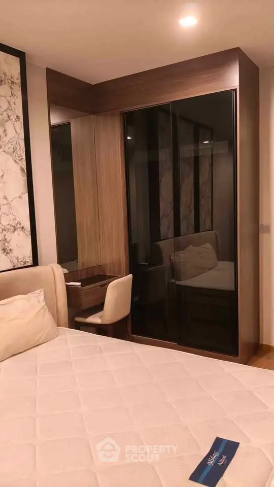 Modern bedroom with stylish decor and built-in wardrobe, perfect for a cozy living space.