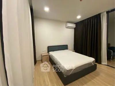 Modern bedroom with sleek design and wooden flooring