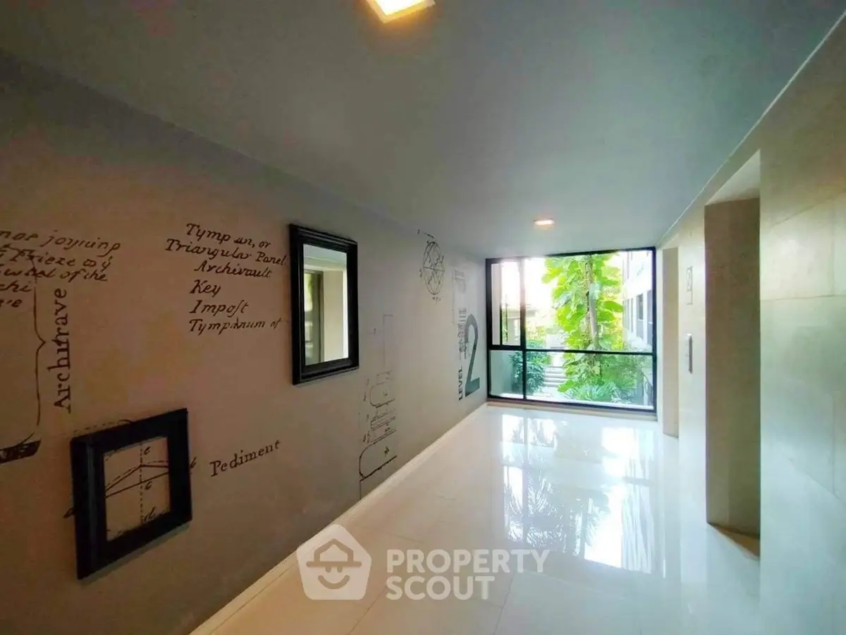 Modern corridor with artistic wall design and large window view