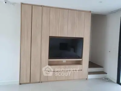 Modern living room with built-in wooden TV cabinet and sleek design