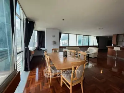 Spacious corner unit with big living room and city view, featuring elegant wooden flooring and modern furniture.