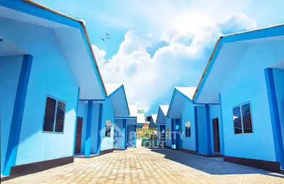 Charming blue houses with pitched roofs under a bright sky, perfect for serene living.
