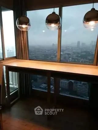 Stunning high-rise apartment with panoramic city view and modern lighting fixtures.