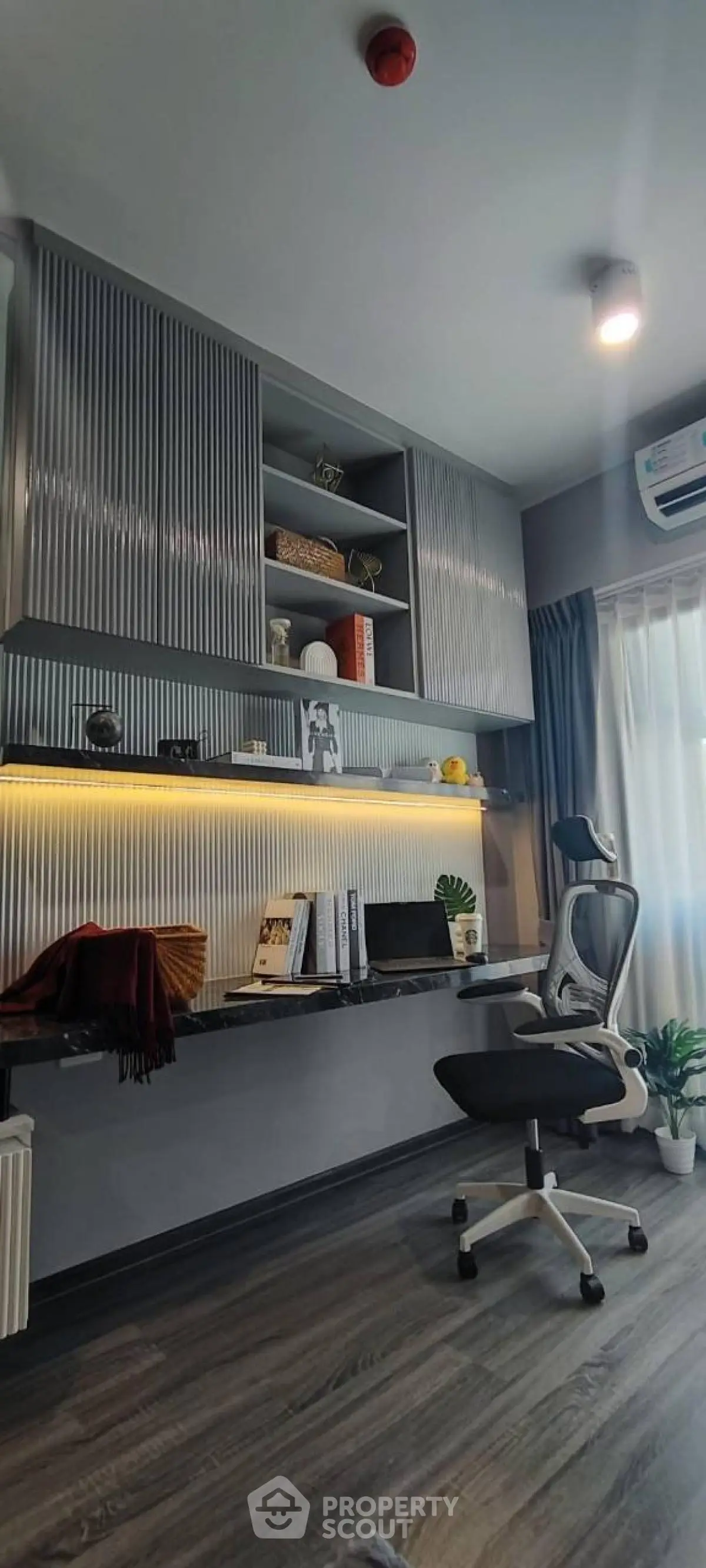 Modern study room with sleek desk, ergonomic chair, and stylish shelving.