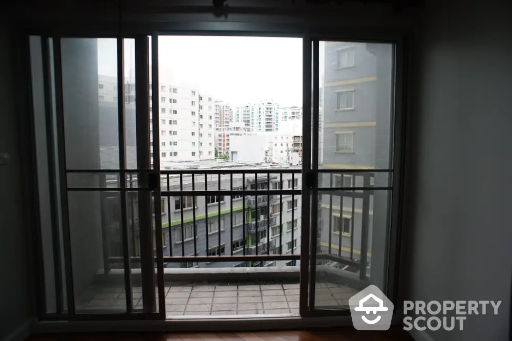 Spacious balcony with city view in modern apartment building