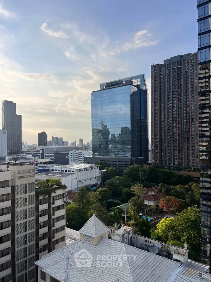 Stunning cityscape view with modern high-rise buildings and lush greenery, perfect for urban living.