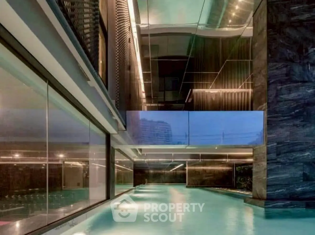 Luxurious indoor pool with modern architectural design and ambient lighting