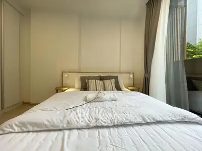 Bright and cozy bedroom with large window and elegant decor