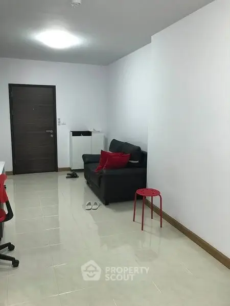 Modern living room with minimalist decor and sleek furniture in a cozy apartment.