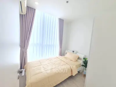 Bright and cozy bedroom with large window and modern decor