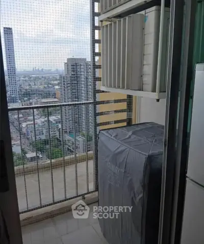 High-rise balcony with laundry area and city skyline view, perfect for urban living.