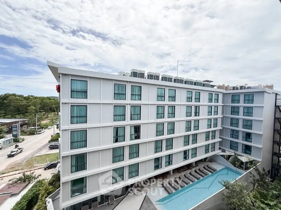 Modern apartment building with rooftop pool and scenic view