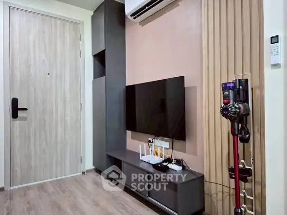 Modern living room with sleek TV setup and stylish storage solutions.