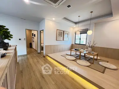 Elegant Japanese-style living room with tatami mats and modern lighting