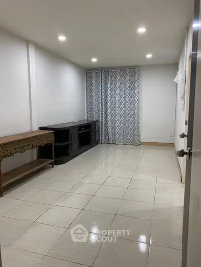 Spacious unfurnished room with tiled flooring and modern lighting, ideal for customization.