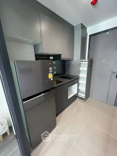 Modern kitchen with sleek cabinetry and stainless steel appliances in a compact layout.