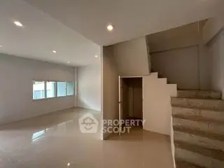 Spacious modern living room with staircase and natural light