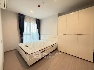 Modern bedroom with sleek wardrobe and cozy bed in bright apartment