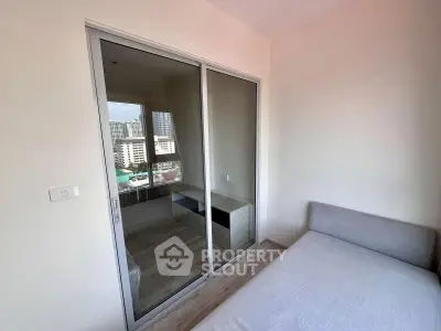 Modern bedroom with sliding glass doors and city view