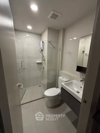 Modern bathroom with glass shower and sleek fixtures