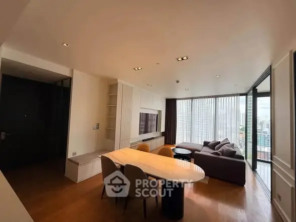 Spacious modern living room with city view, featuring elegant furniture and ample natural light.