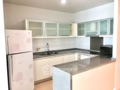 Modern kitchen with sleek cabinets and granite countertops in a stylish apartment.