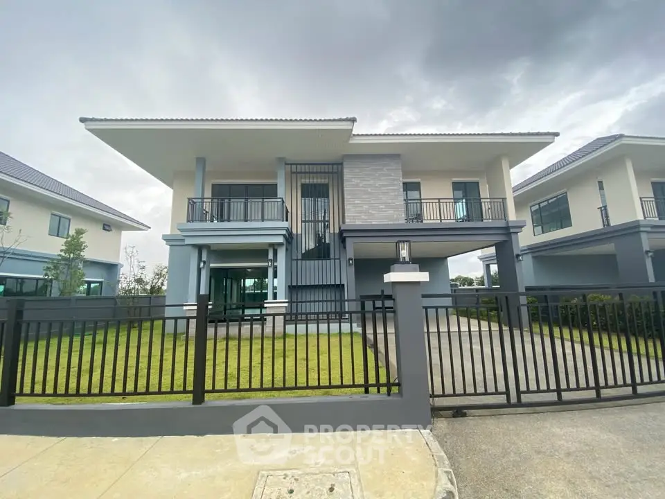 Modern two-story house with sleek design and spacious front yard
