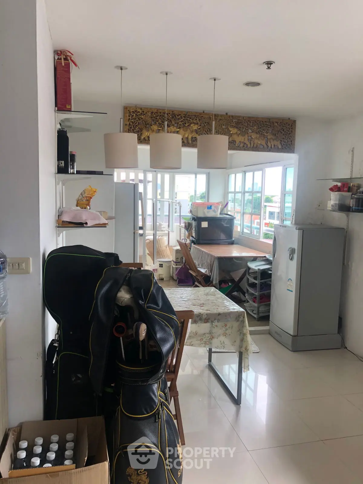 Spacious kitchen with dining area and large windows offering natural light.