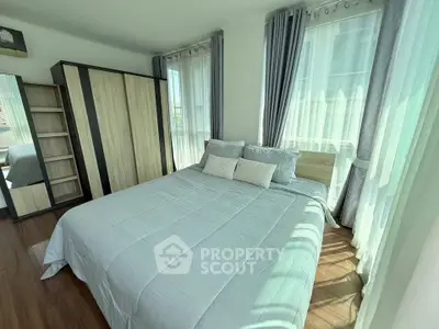 Bright and airy bedroom with modern decor and large windows