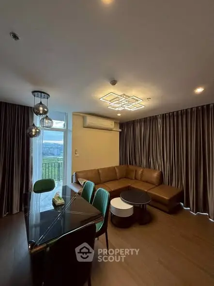 Modern living room with stylish furniture and large windows offering scenic views.