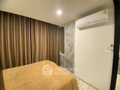 Cozy bedroom with modern air conditioning and elegant curtains