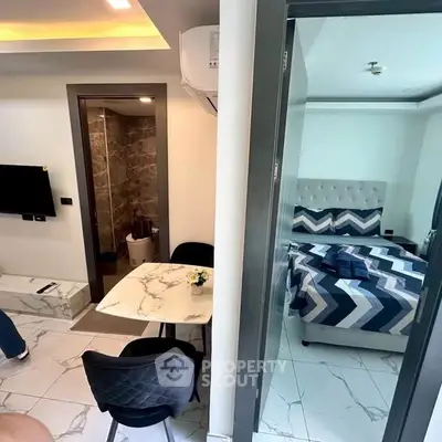 Modern apartment interior with marble floors, cozy bedroom, and stylish dining area.