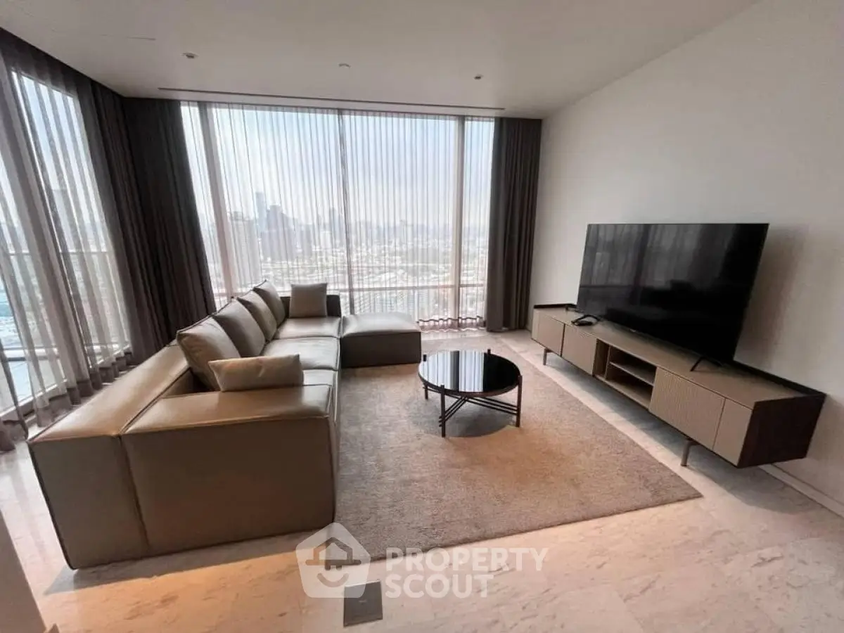Spacious modern living room with large windows and city view