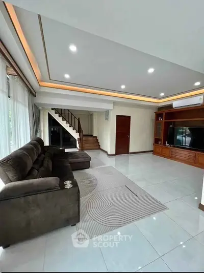 Spacious modern living room with sleek design and cozy seating, perfect for family gatherings.