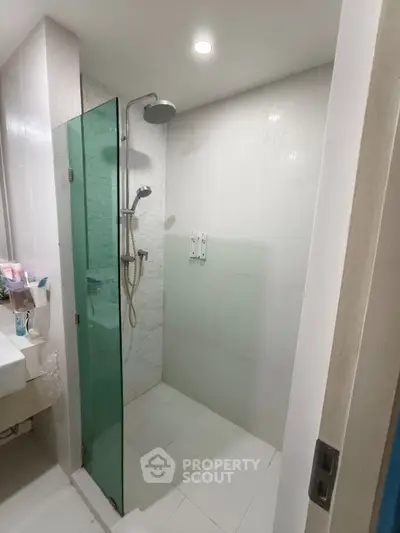 Modern bathroom with glass shower enclosure and sleek fixtures