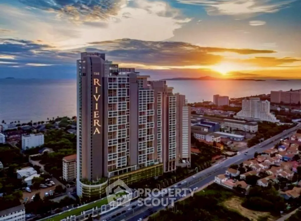 Stunning high-rise building with ocean view at sunset, perfect for luxury living.
