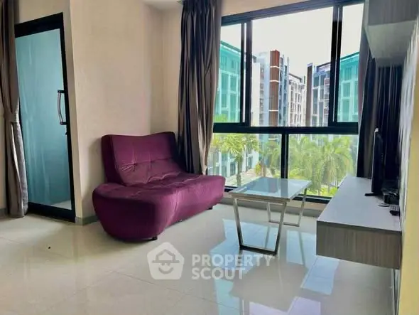 Modern living room with stylish sofa and large windows offering a scenic view.