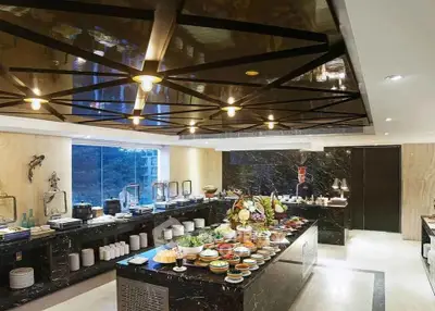 Luxurious modern kitchen with elegant black marble countertops and open layout.