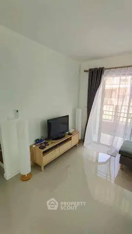 Bright living room with modern TV stand and large window view
