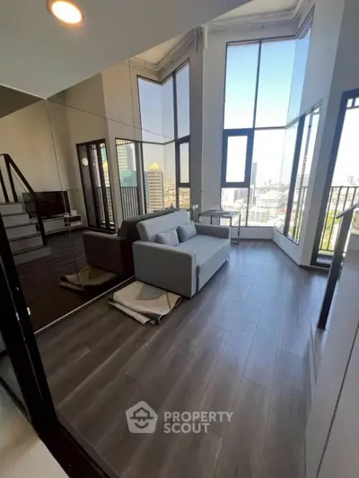 Modern high-rise condo with floor-to-ceiling windows and stunning city view