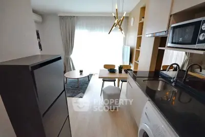 Modern compact living room with open kitchen and stylish decor