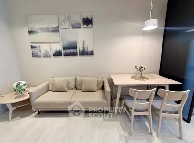 Modern living room with beige sofa, dining table, and minimalist decor