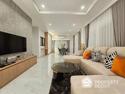 Luxurious modern living room with elegant decor and spacious seating area.